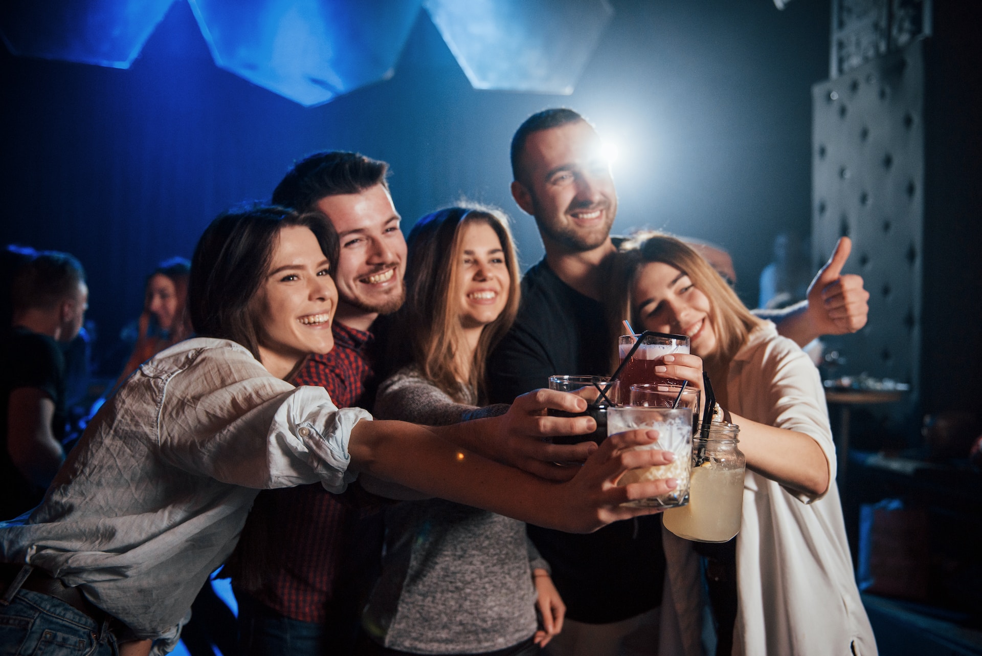 people with drinks at a nightclub